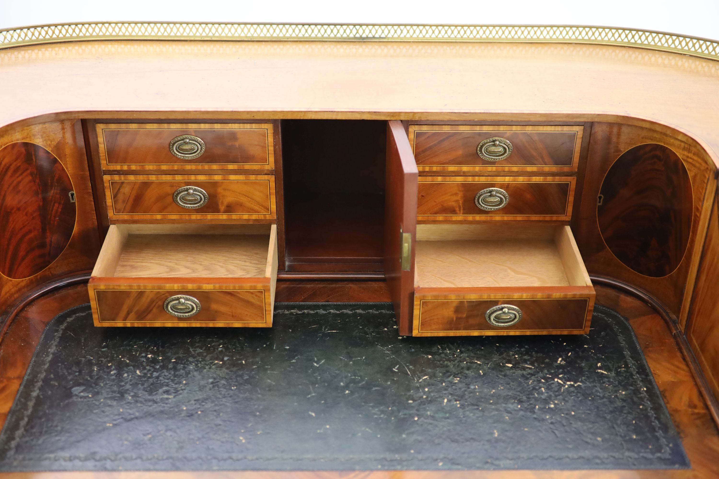 An Edwardian Sheraton revival satinwood banded mahogany Carlton House desk, W.138cm D.65cm H.104cm